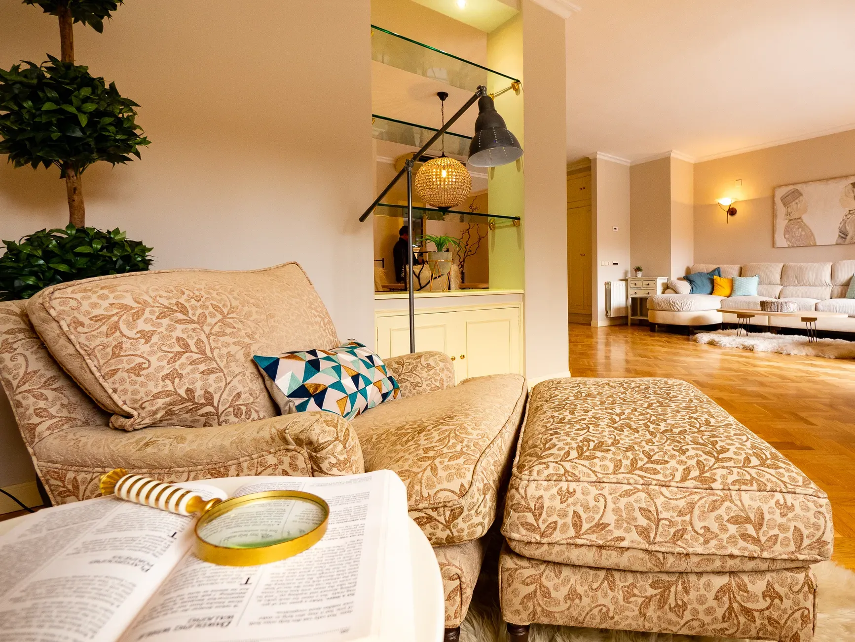 Elegant lounge area featuring a floral armchair and warm lighting in Madrid.